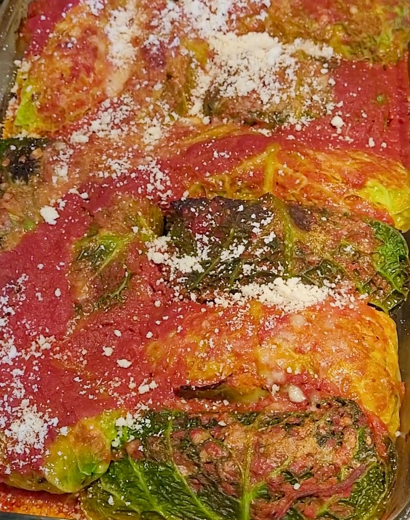 Cabbage rolls after being baked wit sauce and cheese